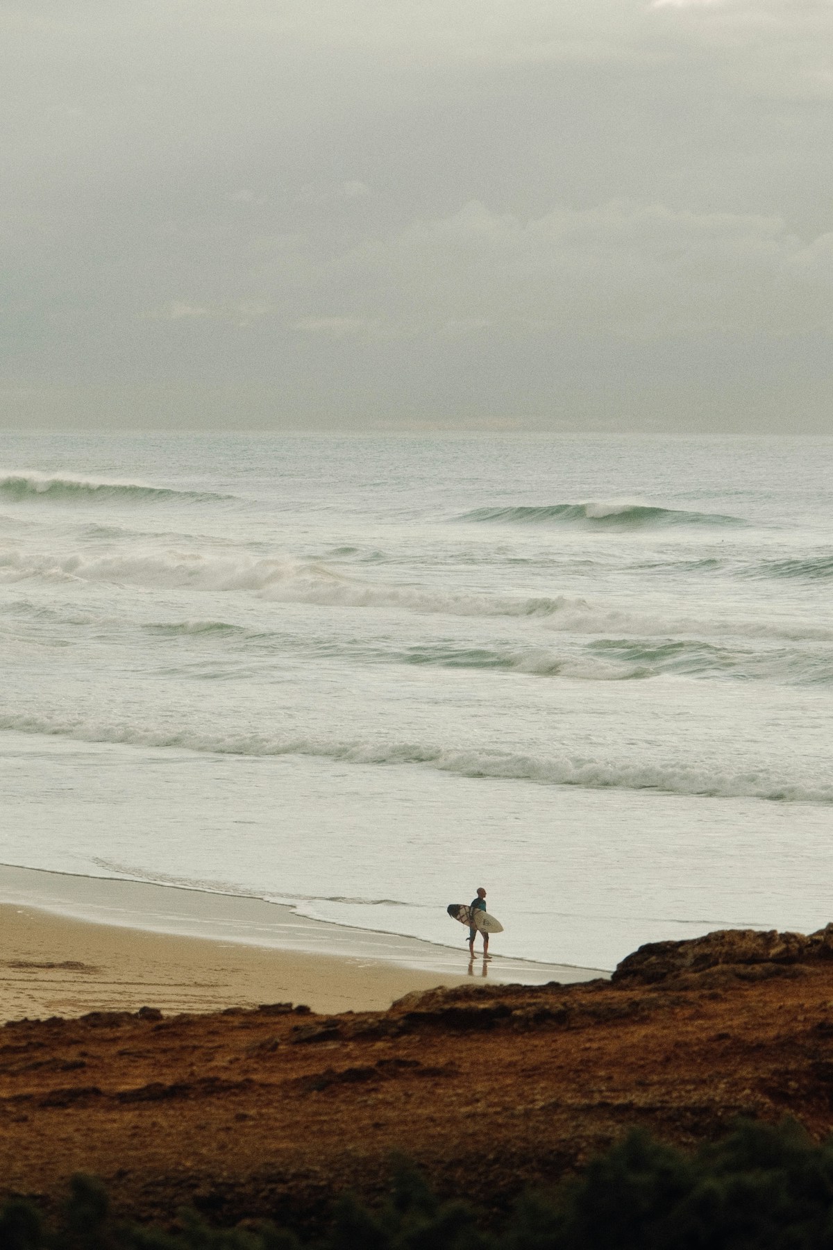 Surfer walking towards the ocean at CroCro
